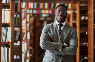 Male Education major stands in the library