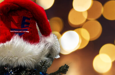 Photo of Christmas tree with ornament and Santa hat with NEC logo