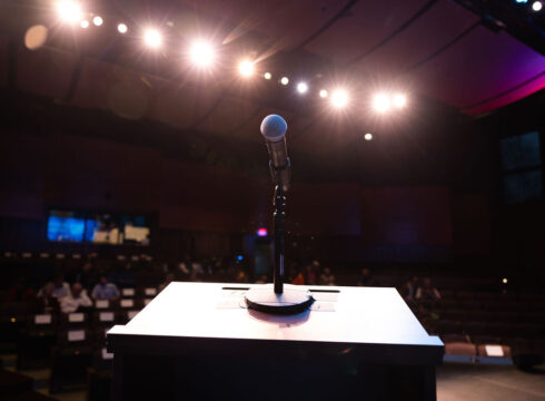 Podium and microphone set up in the Rosamond Page Putnam Center for the Performing Arts for a political debate at New England College.