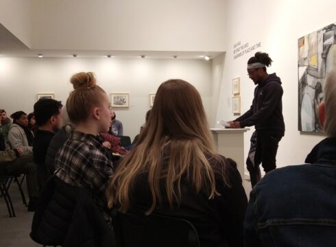 Creative Writing student at New England College reads original work at a student reading event.